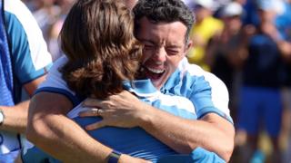 Rory McIlroy and Tommy Fleetwood embrace after winning their Ryder Cup foursomes match