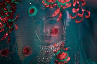 A transgender woman waits backstage.