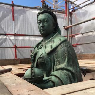 A statue of Queen Victoria with scaffolding