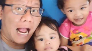 Muhammad Shalehan with his two daughters, aged two and three