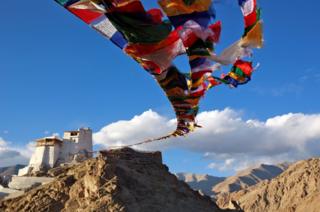 Prayer flags fly at Namgyal Tsemo Monastery above the town of Leh in Ladakh, India.