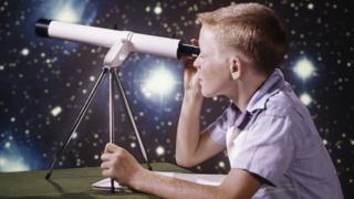 child-looking-through-telescope
