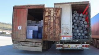 Lorries loaded with aid wait at the Turkey-Syria border
