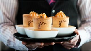 Edible coffee cups are pictured on an Air New Zealand plane