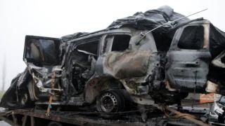 The damaged vehicle that drove over a mine while transporting members of the Organization for Security and Cooperation in Europe (OSCE), who were killed and injured from the incident on Sunday, is moved from the scene in Luhansk region, Ukraine, April 23, 2017.