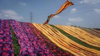 A worker throws a cloth