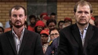 Pieter Doorewaard, 28, (L) and Philip Schutte, 35, (R), wait for their sentencing procedure on March 6, 2019 at the Mahikeng High Court in Mahikeng, South Africa.