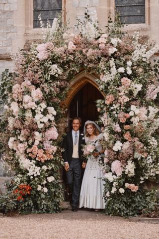 Princess Beatrice and Edoardo Mapelli Mozzi leaving through the flower-covered archway of the Royal Chapel of All Saints at Royal Lodge, Windsor after their wedding