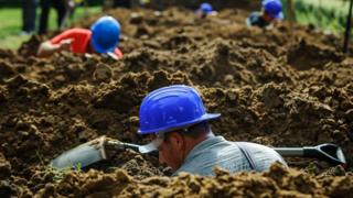 Work in progress during the first National Grave Digging Competition in the public cemetery of Debrecen, 3 June 2016.