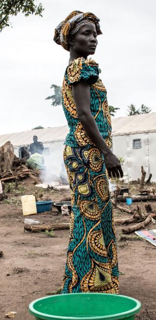 A South Sudanese woman standing in a colourful dress - Saturday 11 May