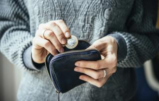 Woman takes money out of purse