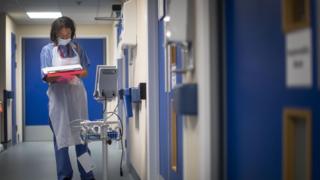 A doctor checks on patient notes as the first patients are admitted to the NHS Seacole Centre at Headley Court, Surrey on May 28, 2020, a disused military hospital, which has been converted during the novel coronavirus COVID-19 pandemic.