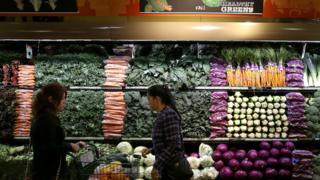 Customers shop for produce at a Whole Foods market on October 15, 2014 in San Francisco, California.