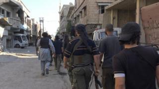 Photo published by pro-IS news agency, Amaq, purportedly showing jihadists on street in Qadam district of Damascus (30 August 2015)