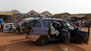 Travellers wey siddon inside moto