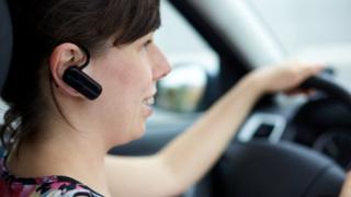 Woman with hands-free mobile