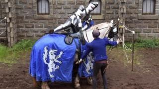 A jouster climbs on to his horse in Victoria, Australia