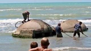Bunkers on a beach being removed
