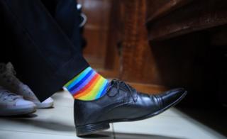 A Kenyan LGBT activist wears rainbow socks as he and his friends wait for a court ruling on an anti-homosexual law at a court in Nairobi, Kenya, 22 February 2019