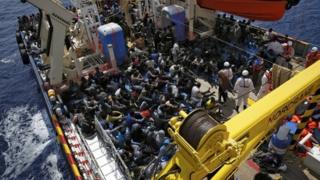 Exhausted migrants rest on the deck of the Migrant Offshore Aid Station (MOAS) ship Topaz Responder after being rescued around 20 nautical miles off the coast of Libya, June 23, 2016