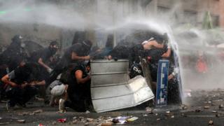 Demonstrators clash with riot police during a protest demanding greater social reform on 12 November, 2019.