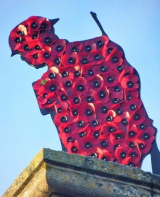 Poppies on a soldier shaped sculpture
