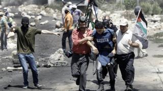 صورة أرشيفية لمواطنين يساعدون مصورا صحفيا