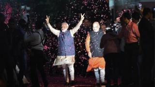 Indian Prime Minister Narendra Modi (L) flashes the victory sign next to president of the ruling Bharatiya Janata Party (BJP) Amit Shah as they celebrate their victory in India's general elections, in New Delhi on 23 May 2019.