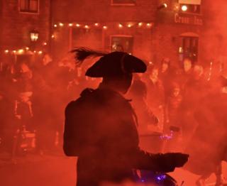Man in a haze of red smoke