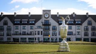 The Claret Jug on the 18th hole in front of Carnoustie Golf Club