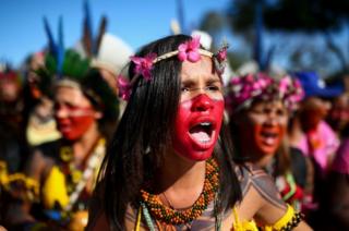 Brazilian indigenous women march towards the Ministry of Health office during a protest against budget cuts, in Brasilia on 12 August 2019.