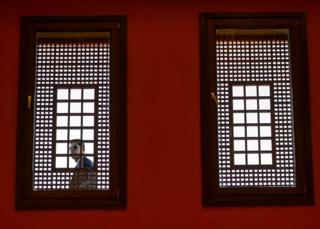 A security guard looking through a window at American University of Cairo in Cairo, Egypt - Thursday 10 January 2019