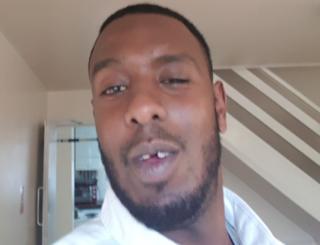 A selfie of Abdi Ali with his front gold tooth removed