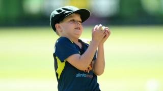 Archie Schiller catches a ball during a warm up with the Australian cricket team