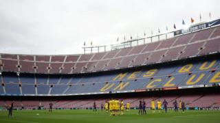 General view as Barcelona's Lionel Messi prepares to take a freekick in the empty stadium