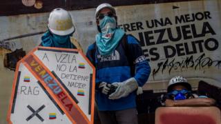 Two masked protesters known under the alias Los Pedros