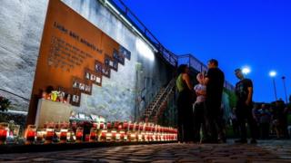 Candles are lit at the scene of the 2010 Love Parade disaster at the memorial site in Duisburg, Germany, July 2018