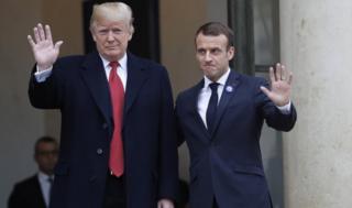 Donald Trump and Emmanuel Macron wave for the camera outside the Elysee Palace in Paris on November 10, 2018.