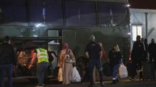 People getting on a bus at a Cyprus airport