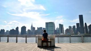 A woman plays a piano in New York in 2010 for the Play Me, I'm Yours project