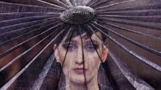 A model presents a creation by designer Giorgio Armani