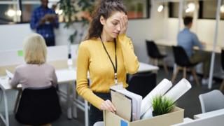 Woman packing up her desk