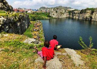 Two children look over Mpape Crushed Rock near Abuja, Nigeria