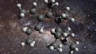   Illustration of a carbon molecule with a background showing the center of a galaxy 