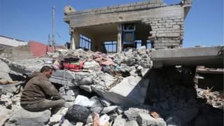 This file photo taken on March 26, 2017 shows an Iraqi man amid the rubble of destroyed houses in the Mosul al-Jadida area, following air strikes in which civilians have been reportedly killed during an ongoing offensive against the Islamic State (IS) group. U