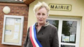 Marie Cau standing in front of the mayor's office in Tilloy-lez-Marchiennes