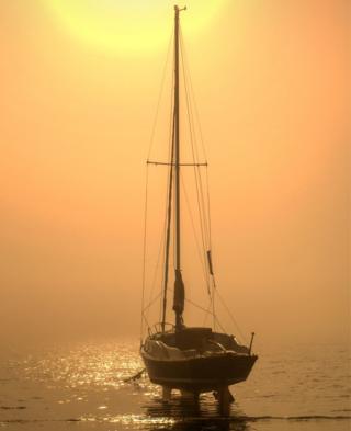 A boat on water at sunrise