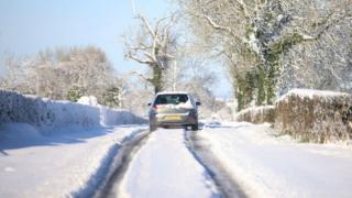 Car driving along a snowy road