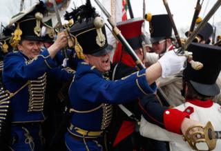 People dressed as Hungarian Hussars and Hapsburg Austrian soldiers re-enact the Battle of Tapiobicske.