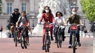 People cycling in facemasks in London.